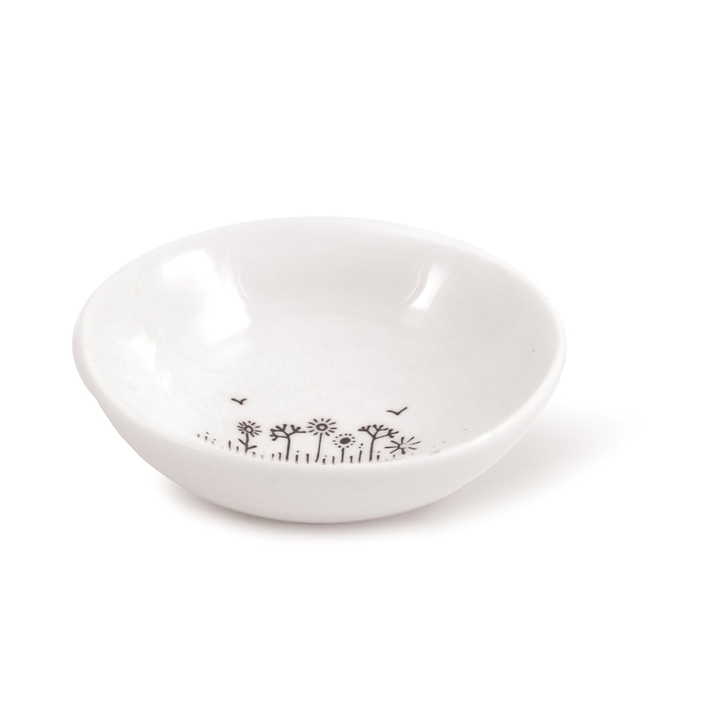 A white ceramic trinket bowl featuring a floral illustration and a quote side