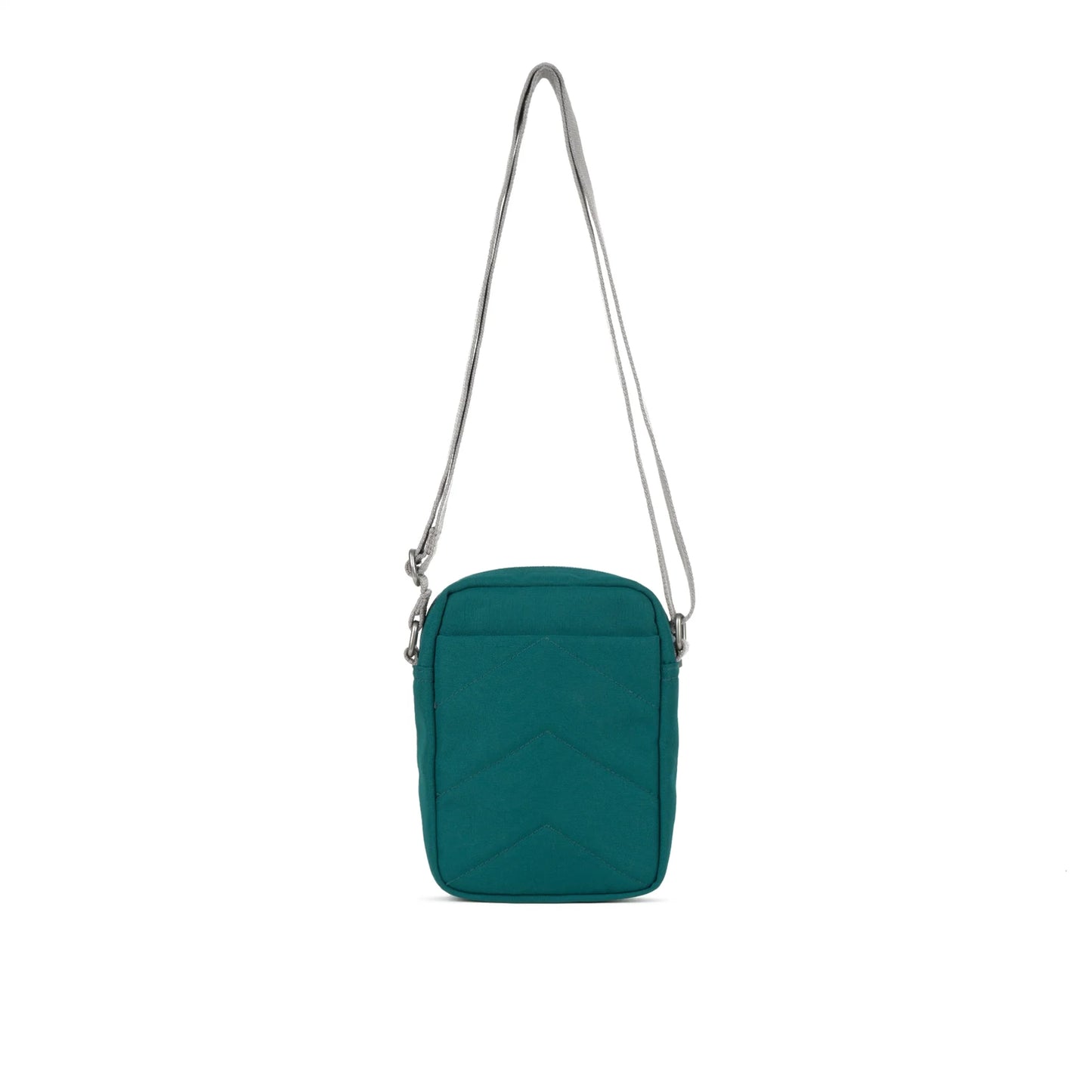 A small crossbody bag in canvas material and teal colour