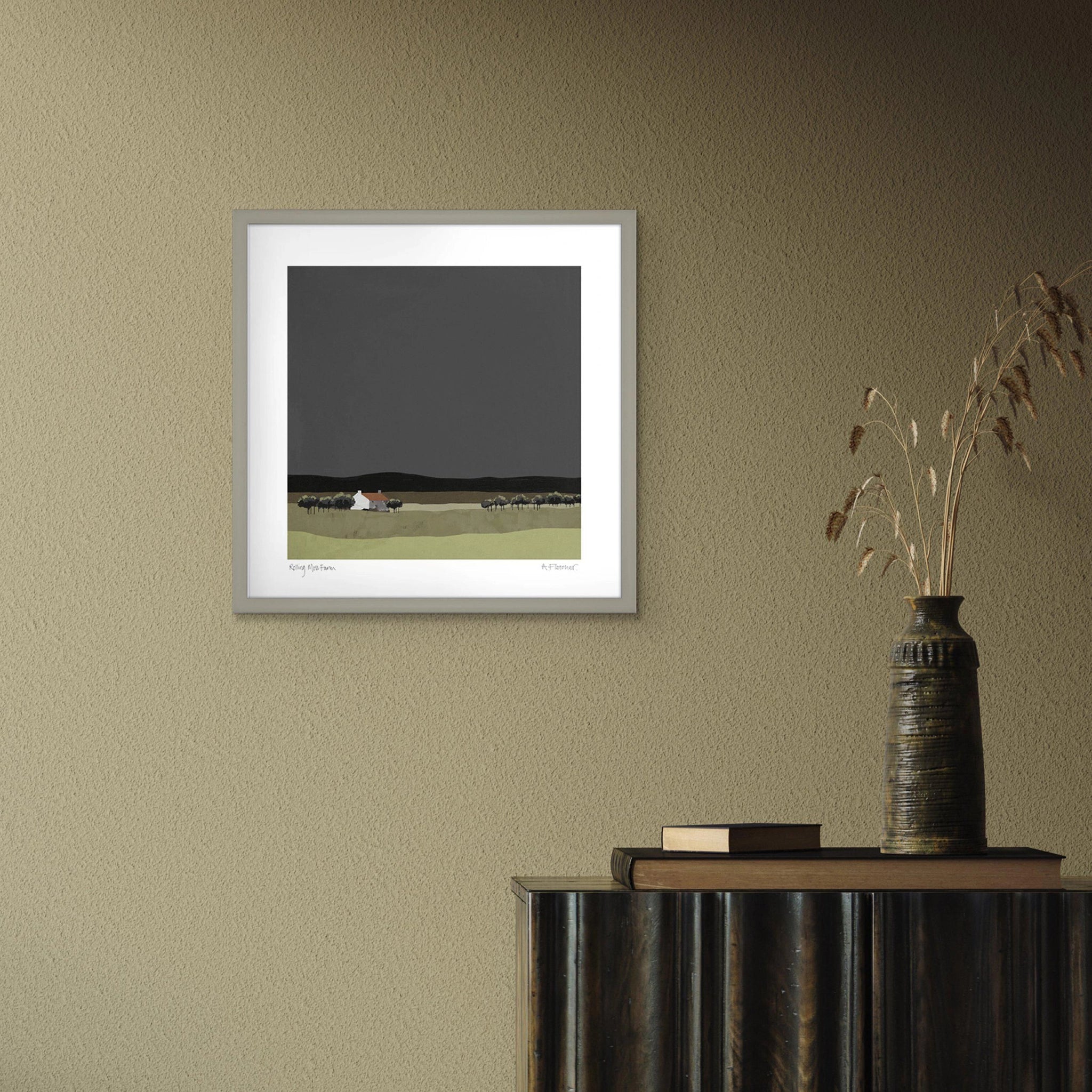 A square framed print featuring a modern landscape painting in muted colours hanging