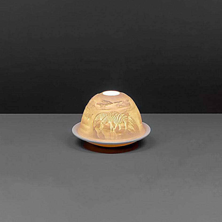 White porcelain dome candle holder with a safari scene back - on