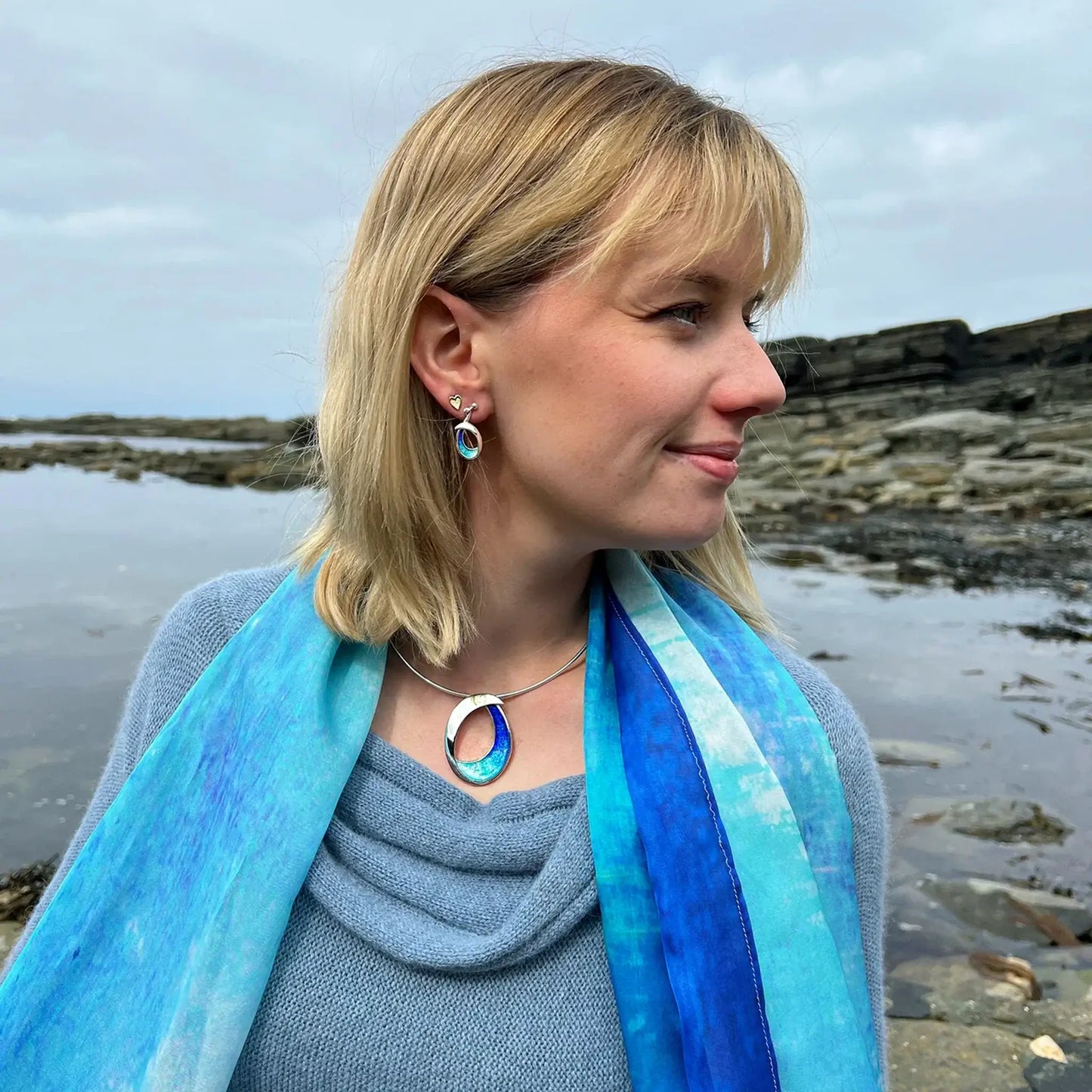Model wearing full set of Sheila Fleet Sea & Surf jewellery, with drop earrings and large necklet