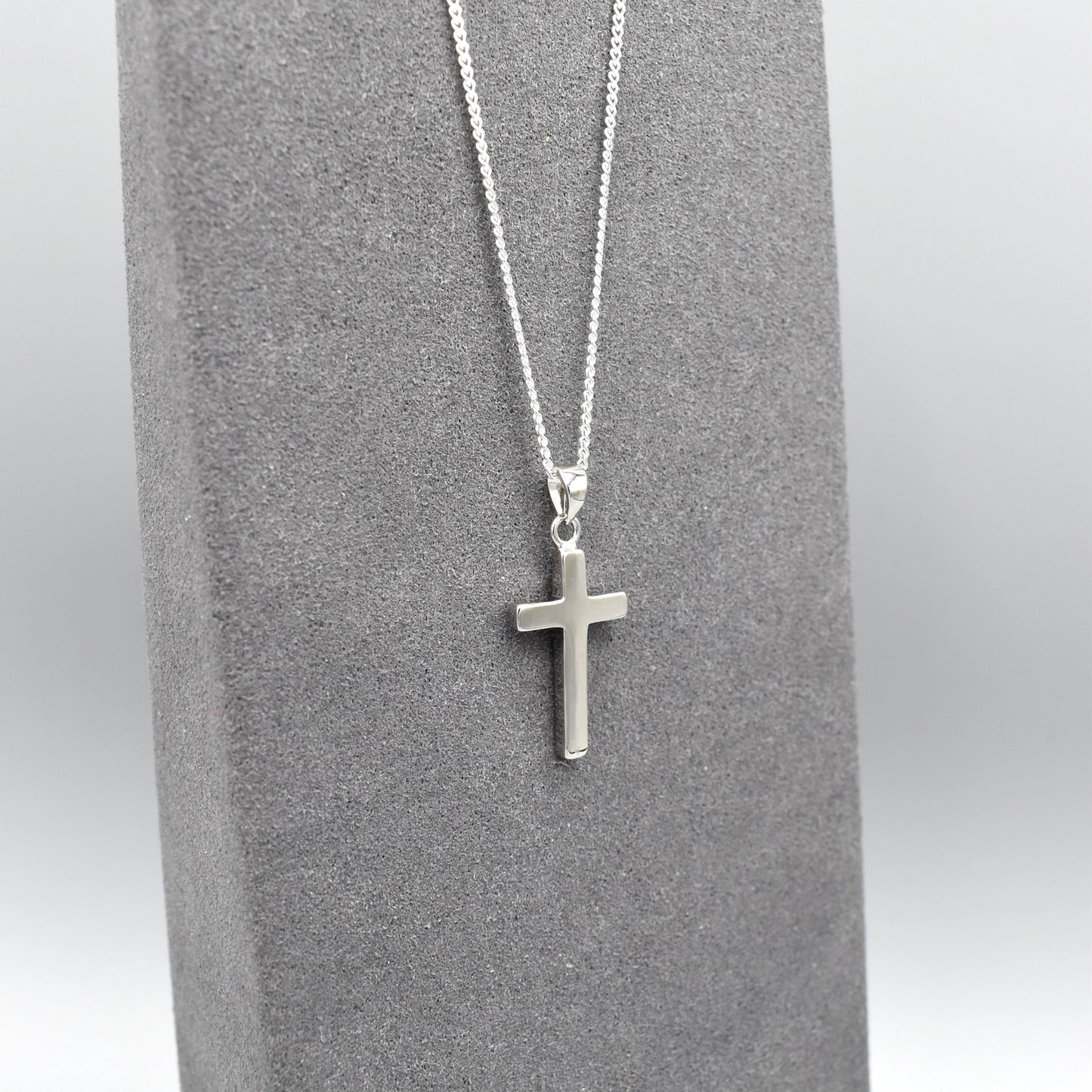 Simple silver cross pendant on silver chain