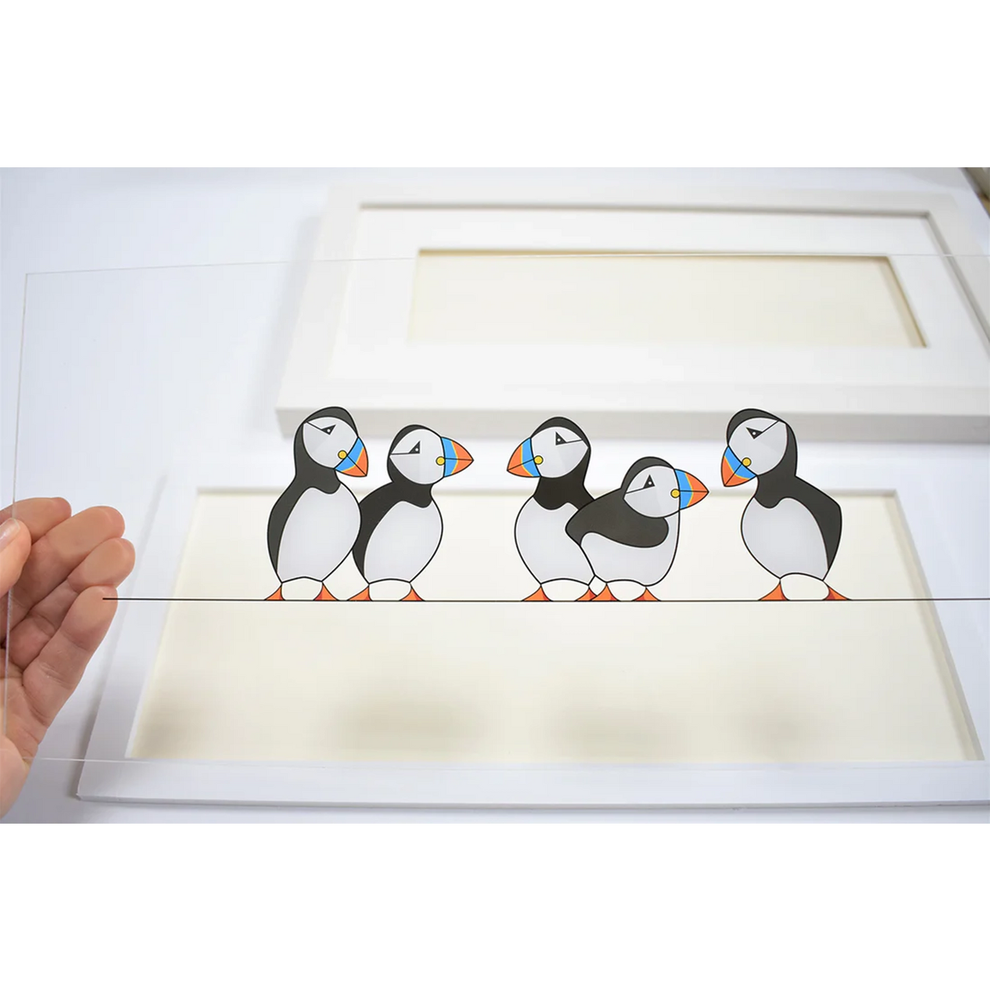 Acrylic art insert featuring a group of chatty puffins