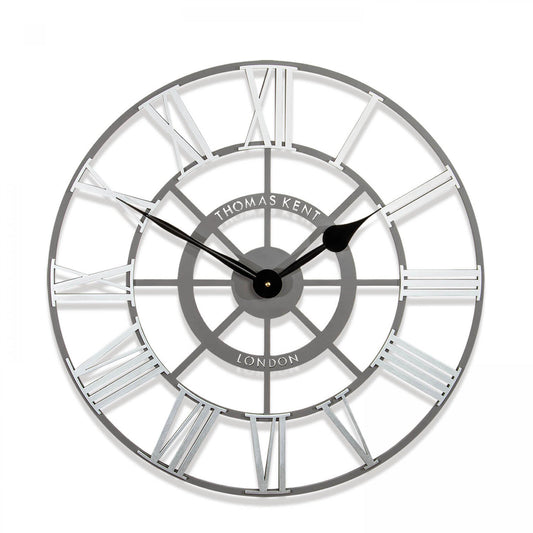 Round skeleton wall clock with grey frame, black hands and silver roman numerals.