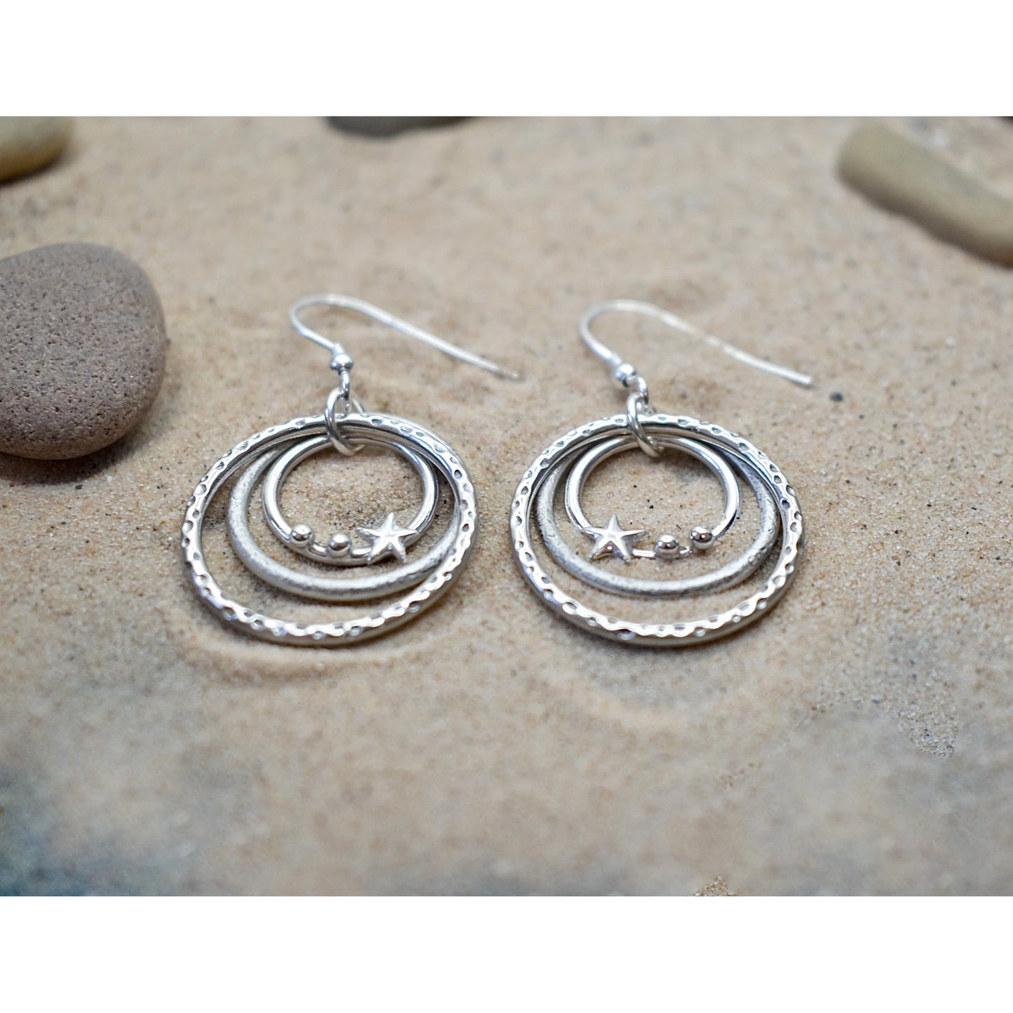 Silver drops with three graduated circles with texture and pebble and star shapes