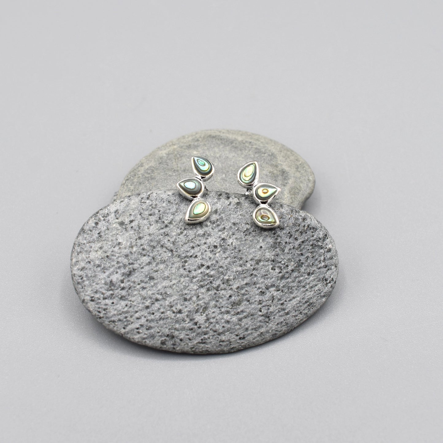 Silver stud earrings with three small teardrop shapes set with paua shell