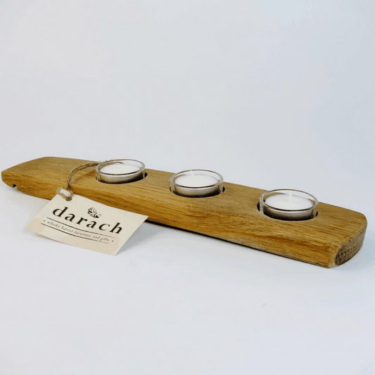 Long wooden tealight holder with three tealight candles in glass holders