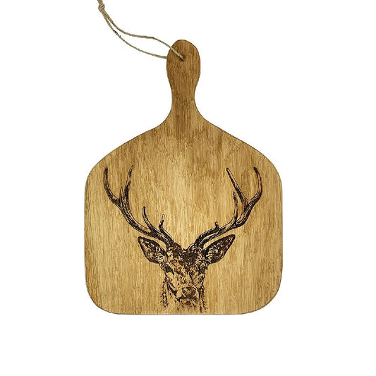 A wooden paddle style serving board with an engraved stag head and hanging loop
