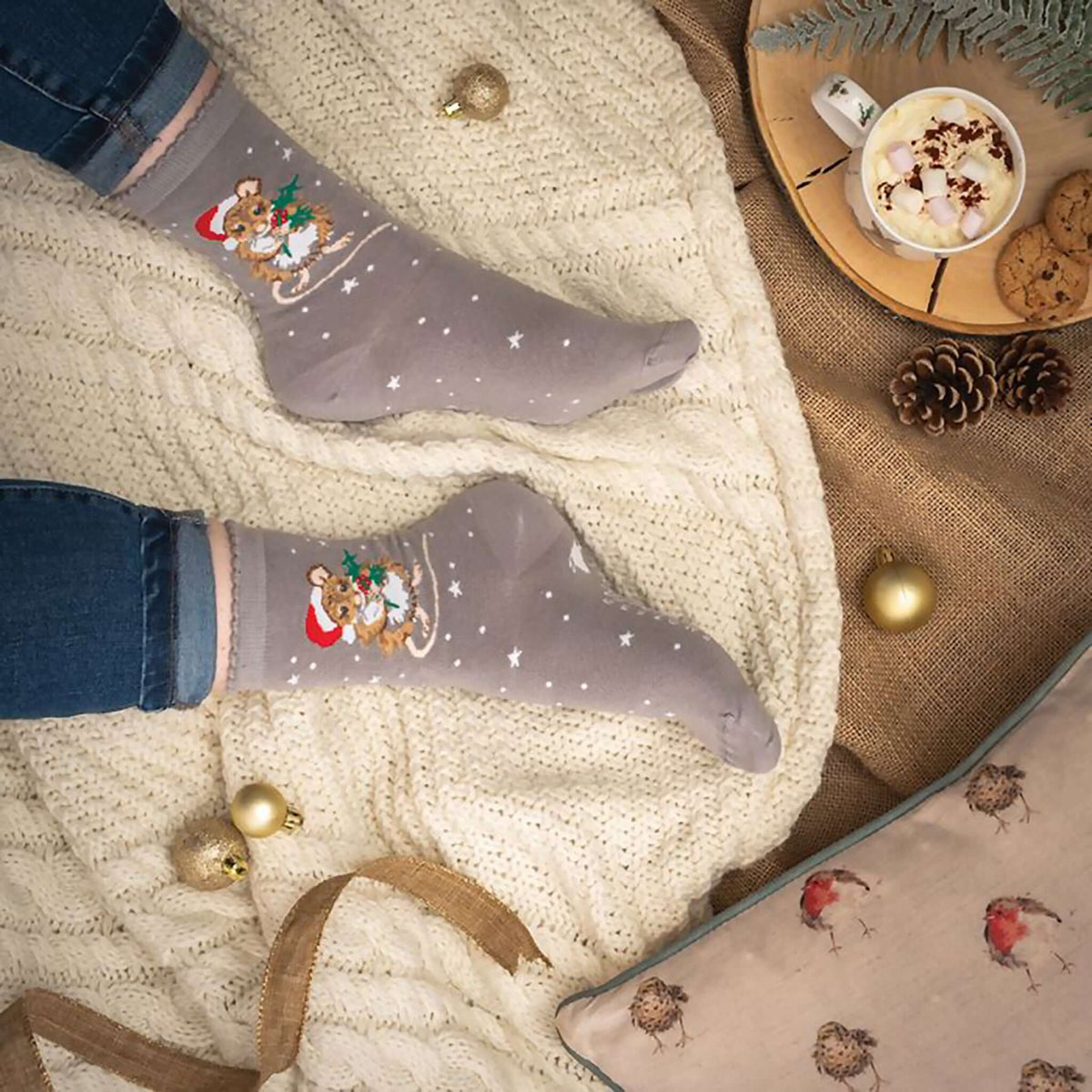 Model wearing grey Christmas mouse in Santa hat socks