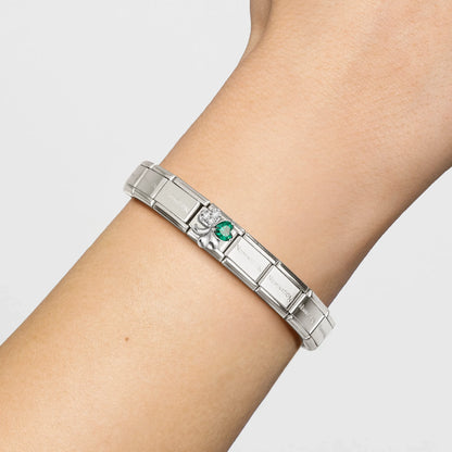 Model wearing Nomination bracelet and link with silver clover and green and white CZ stones