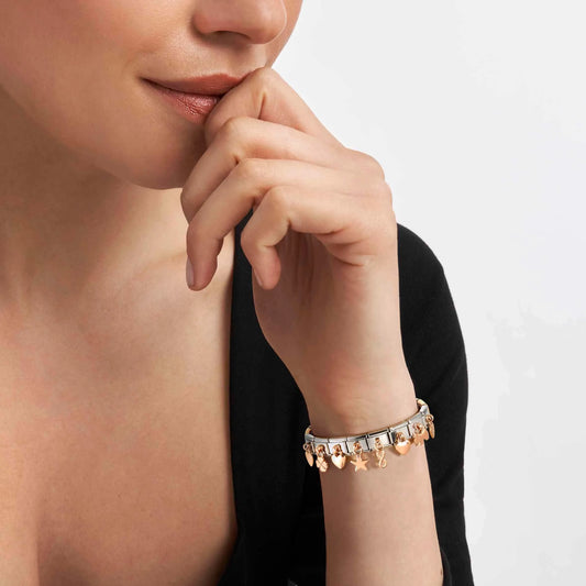 Model wearing bracelet of rose gold Nomination drop charms
