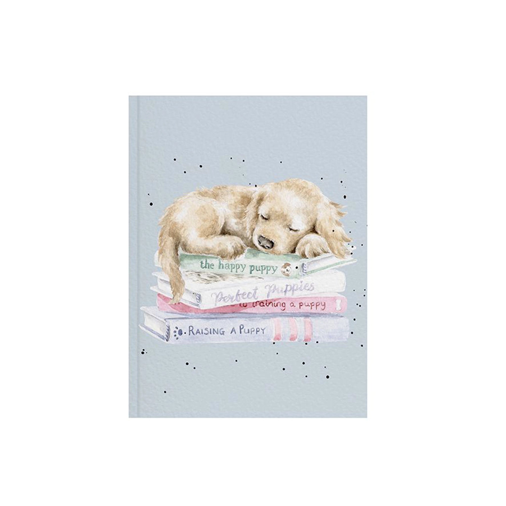 A blue paper notebook featuring an illustration of a labrador puppy sleeping on books