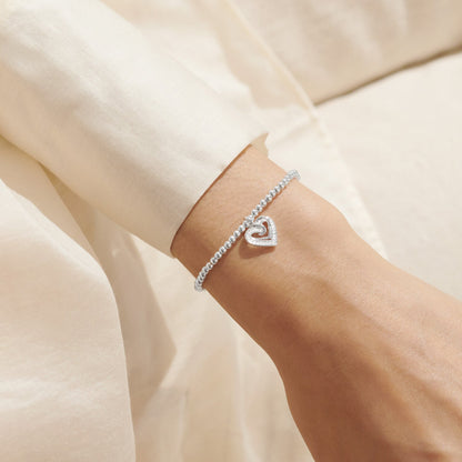 Silver bracelet with CZ heart charm on model