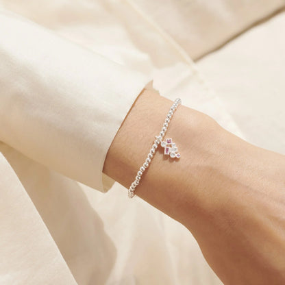 Silver bracelet with CZ constellation charm in pink and white on model