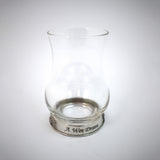 A whisky glass with a pewter base engraved with the words 'A Wee Dram'