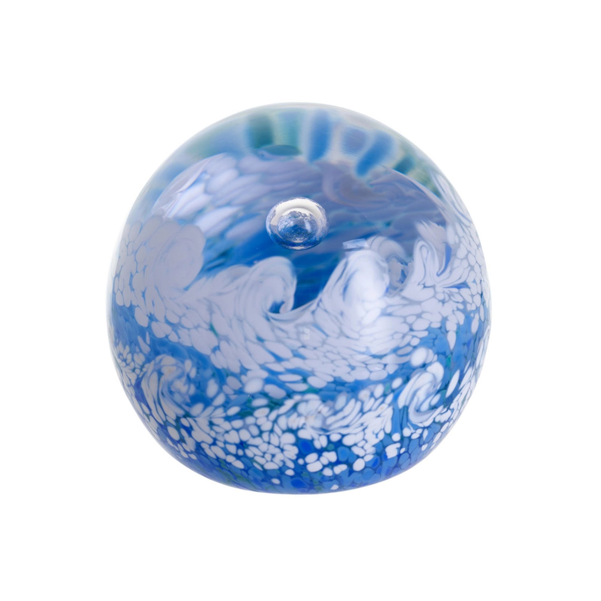 A glass paperweight with blues and white foaming ocean wave shapes