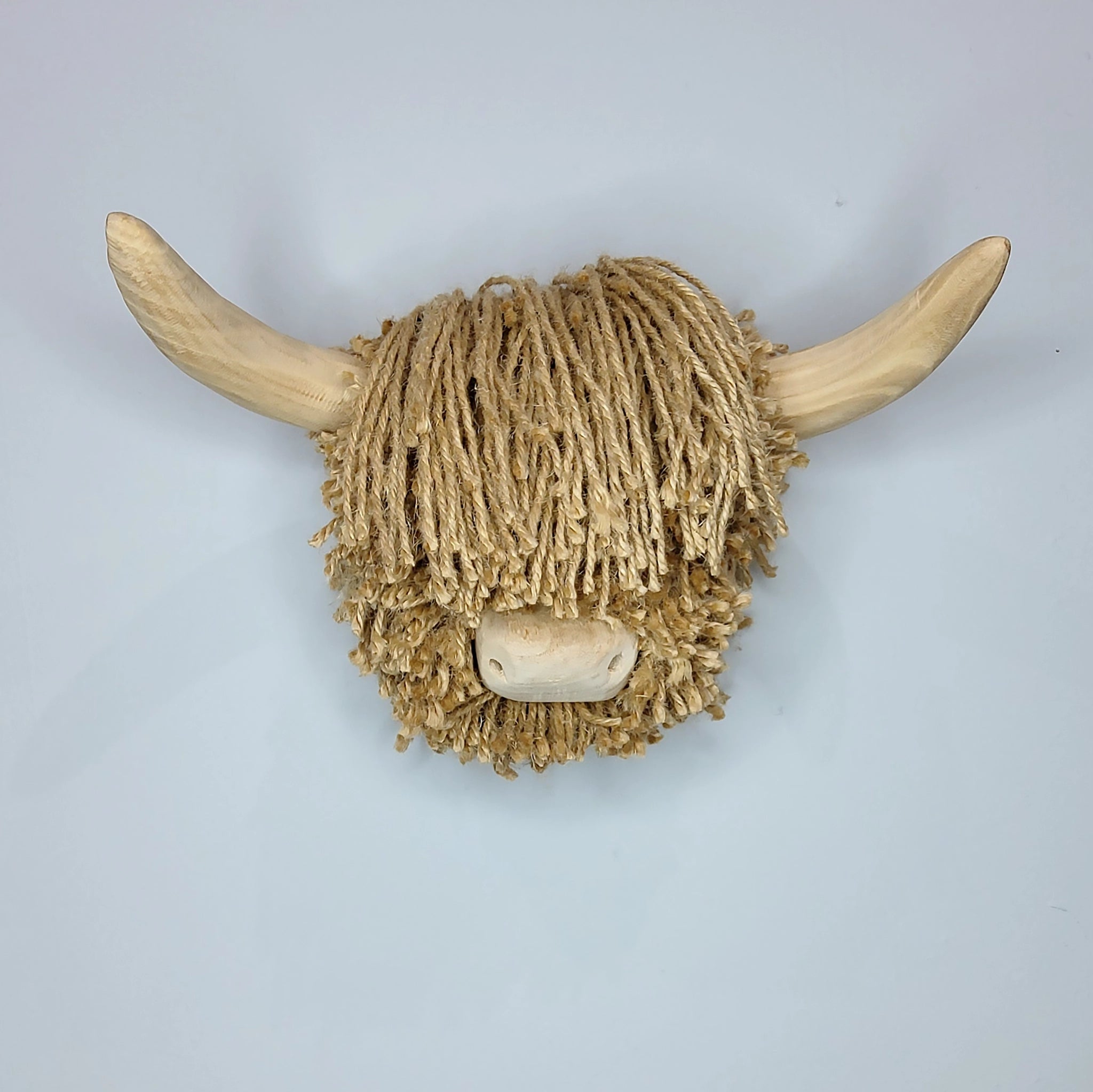 A wall mounted cow head made with natural jute twine