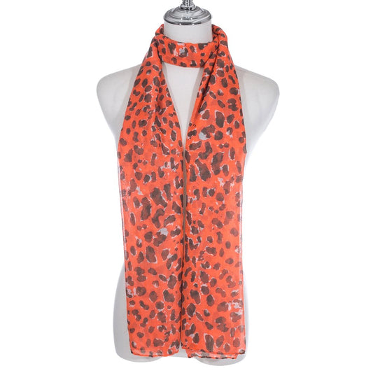 A bright orange scarf with animal print pattern