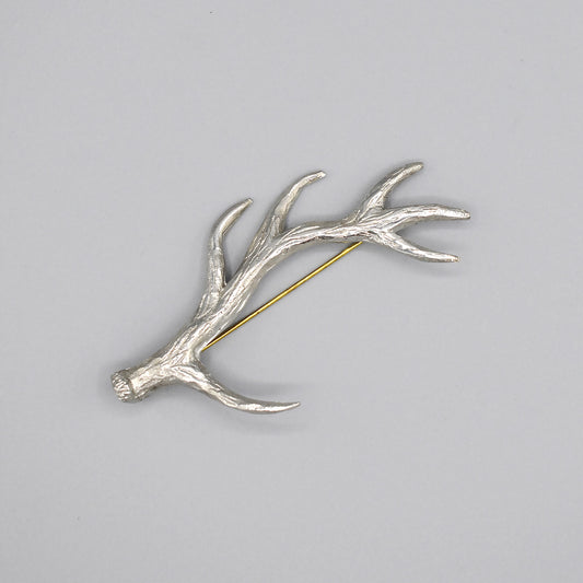 An antler shaped pewter kilt pin