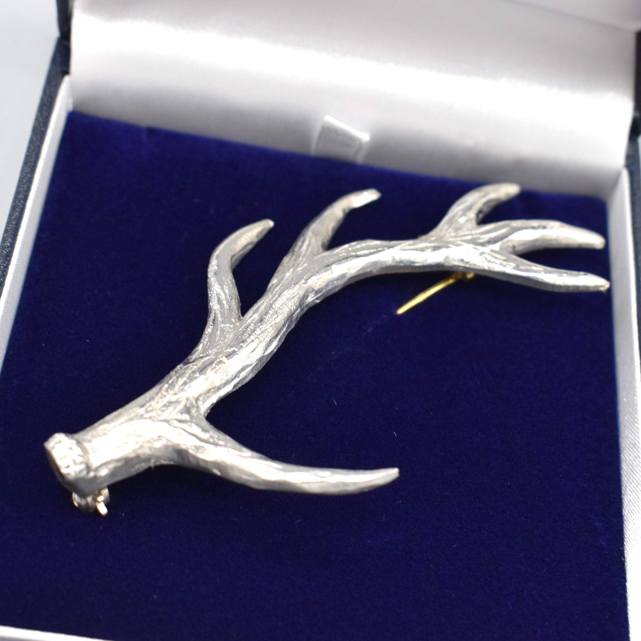 An antler shaped pewter kilt pin detail