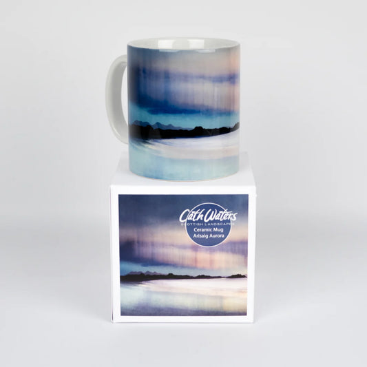 A mug featuring artwork by Cath Waters in blue, pink and purple with box