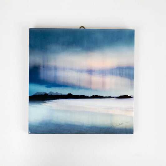 A hanging ceramic square tile featuring an Aurora artwork by Cath Waters 