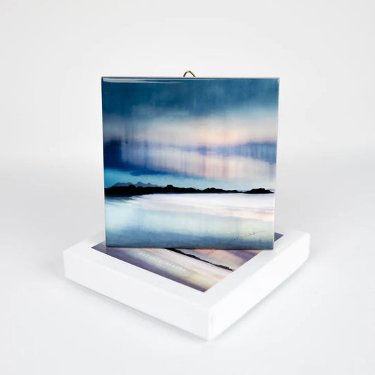 A hanging ceramic square tile featuring an Aurora artwork by Cath Waters with box