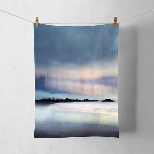 A teal towel featuring an Aurora artwork by Cath Waters in pinks, purples and blues