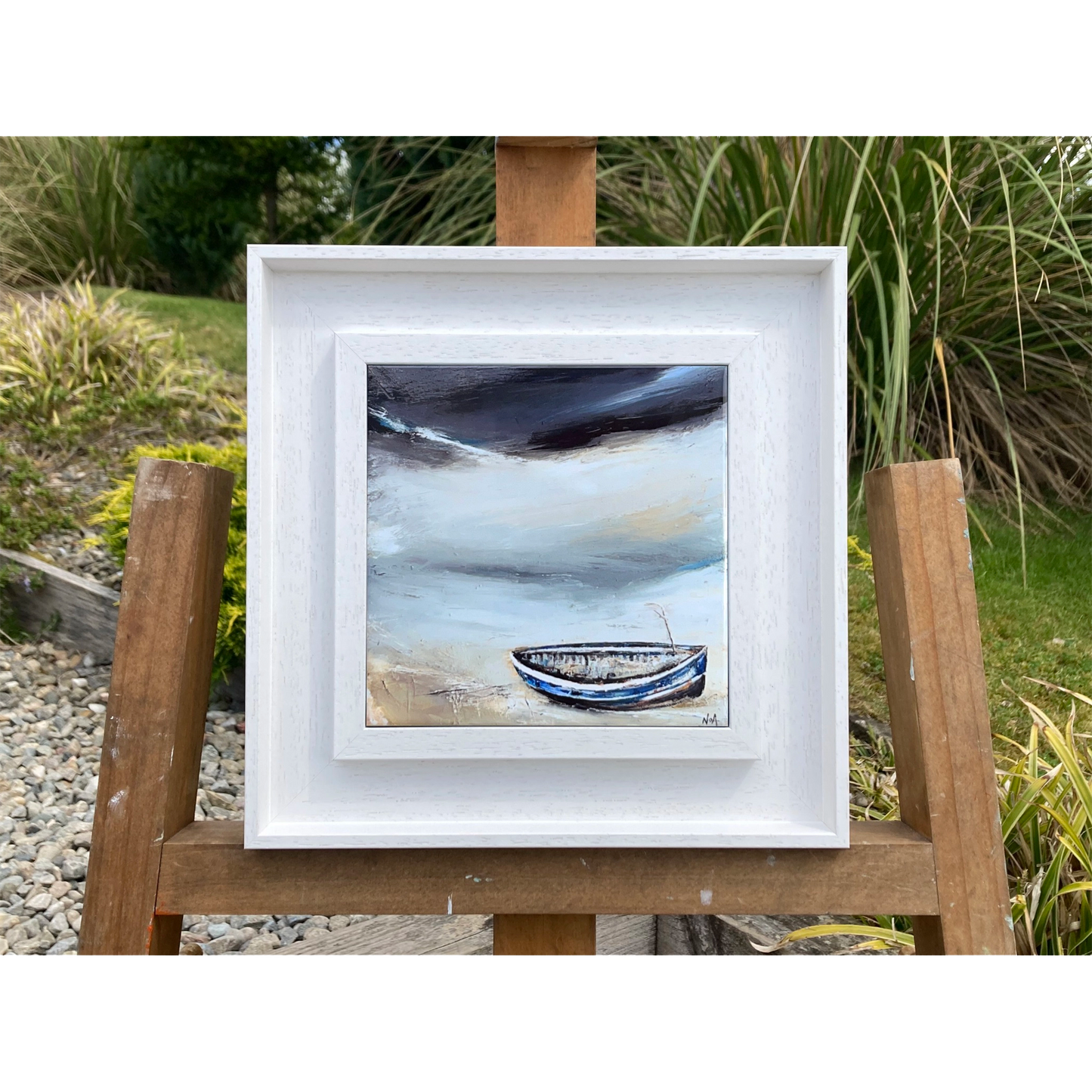 A ceramic tile printed with an abstract painting of a boat on a shoreline mounted on a white frame