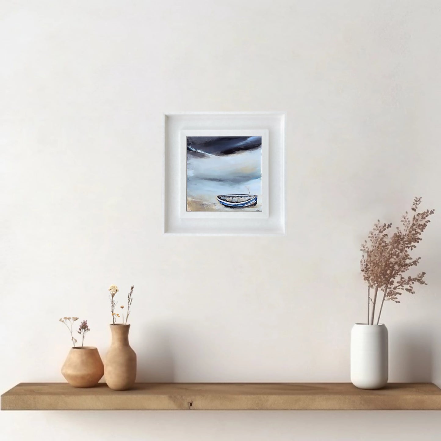 A ceramic tile printed with an abstract painting of a boat on a shoreline mounted on a white frame hanging