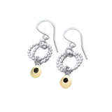 Silver earrings featuring two rings of circles and a dangling gold teardrops