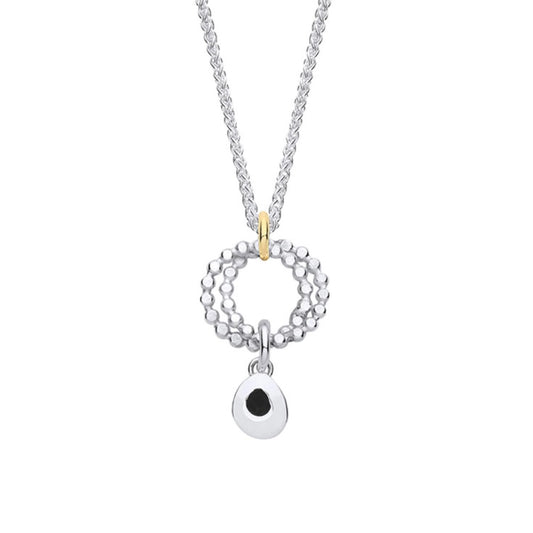  A silver pendant featuring two rings of circles and a dangling silver teardrop