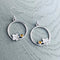 Round loop shaped silver earrings featuring autumn leaves and citrine stones