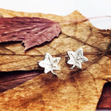 Silver stud earrings shaped like autumn leaves