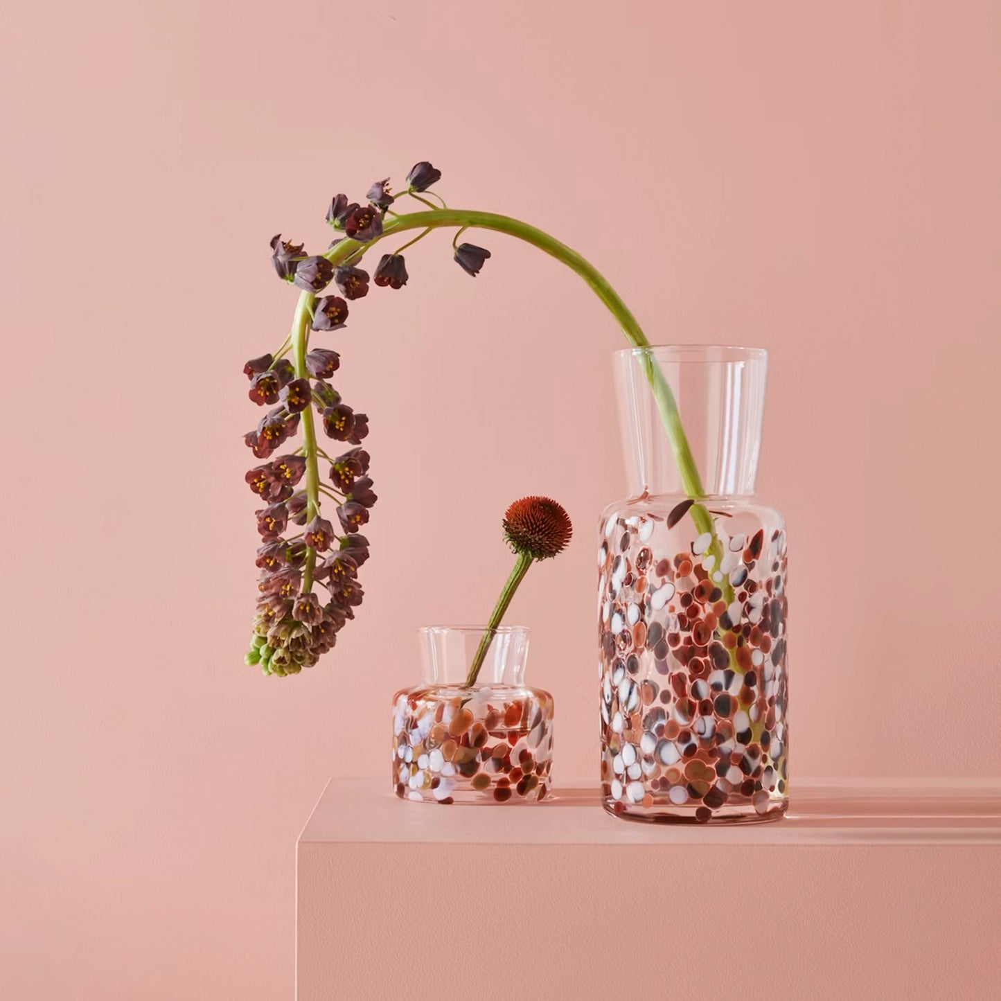 Two glass vases with brown and white pebble details lifestyle