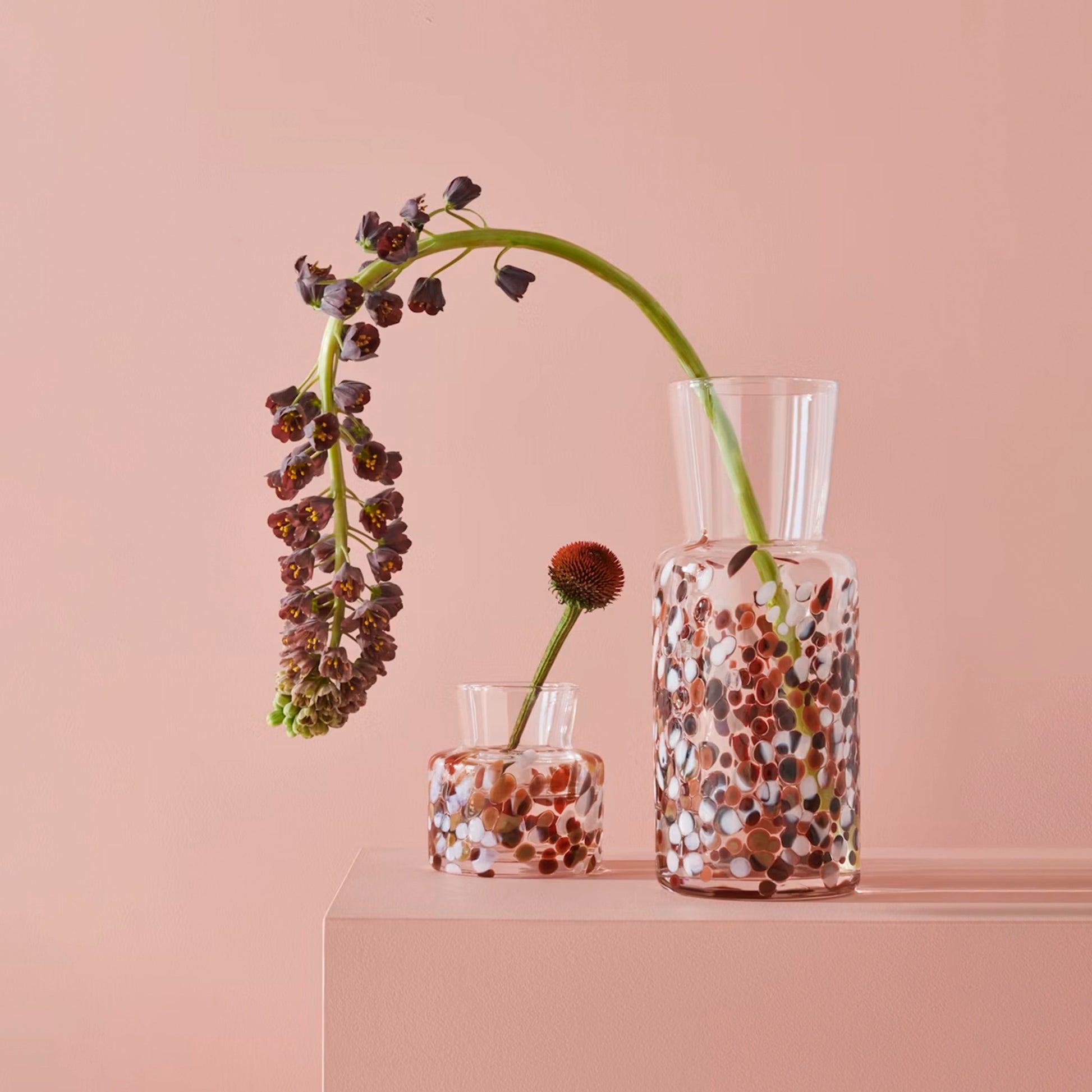 Two glass vases with brown and white pebble details lifestyle