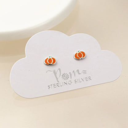 Pair of silver stud earrings shaped like pumpkins with enamelled details on card