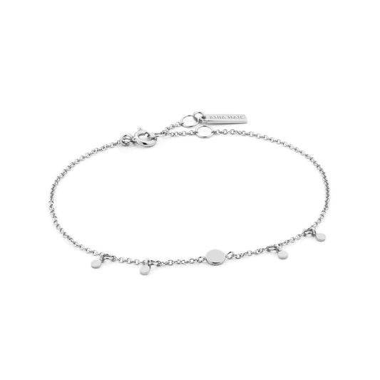 Silver chain bracelet featuring four small disc shaped drops, one larger drop link and an adjustable round clasp closure
