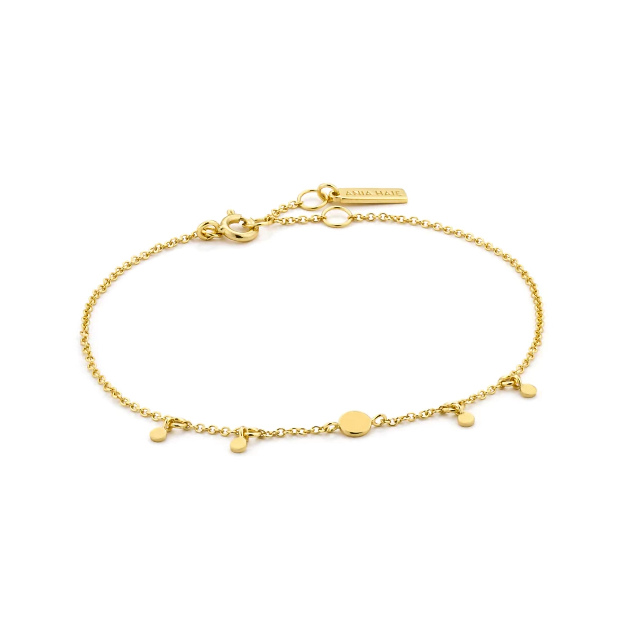 Gold chain bracelet featuring four small disc shaped drops, one larger drop link and an adjustable round clasp closure