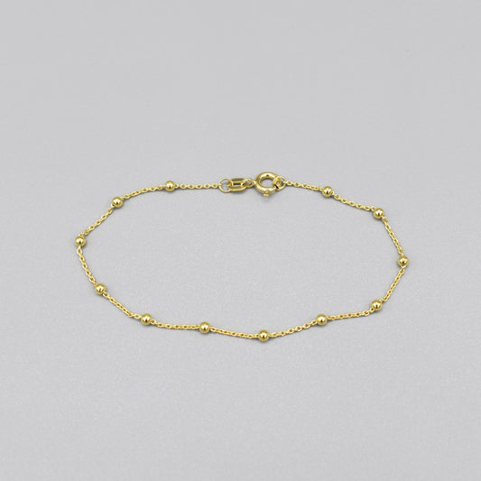 A yellow gold chain bracelet with little round ball details