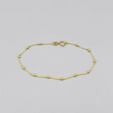 A yellow gold chain bracelet with little round ball details