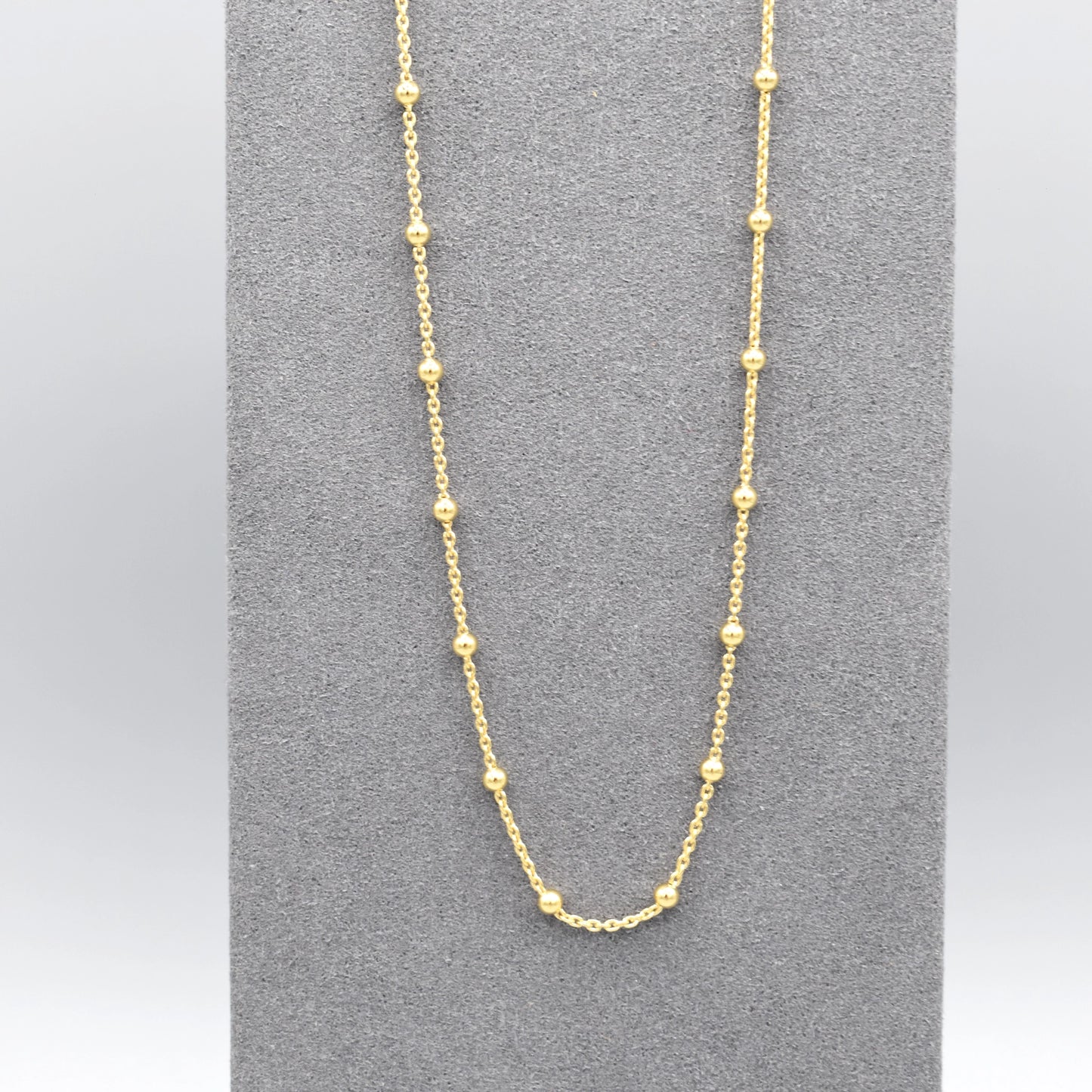 A yellow gold chain necklace with little round ball details