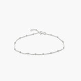 A silver chain anklet with silver ball details