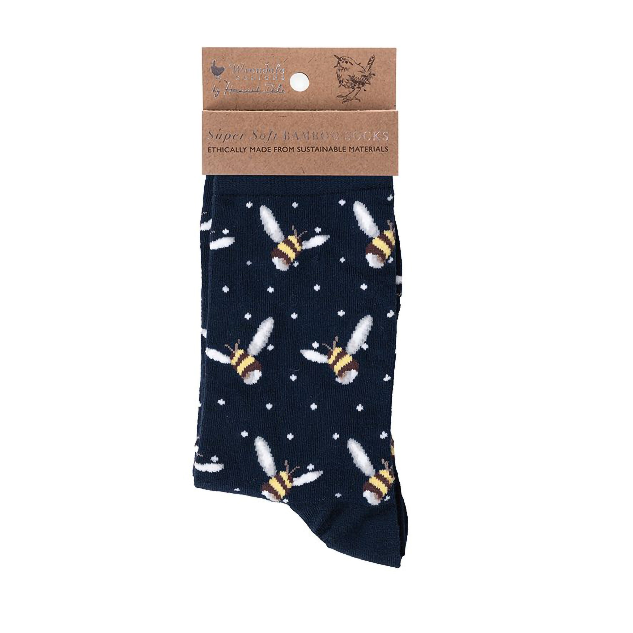 Folded pair of navy blue socks with a bumblebee picture and white polka dots