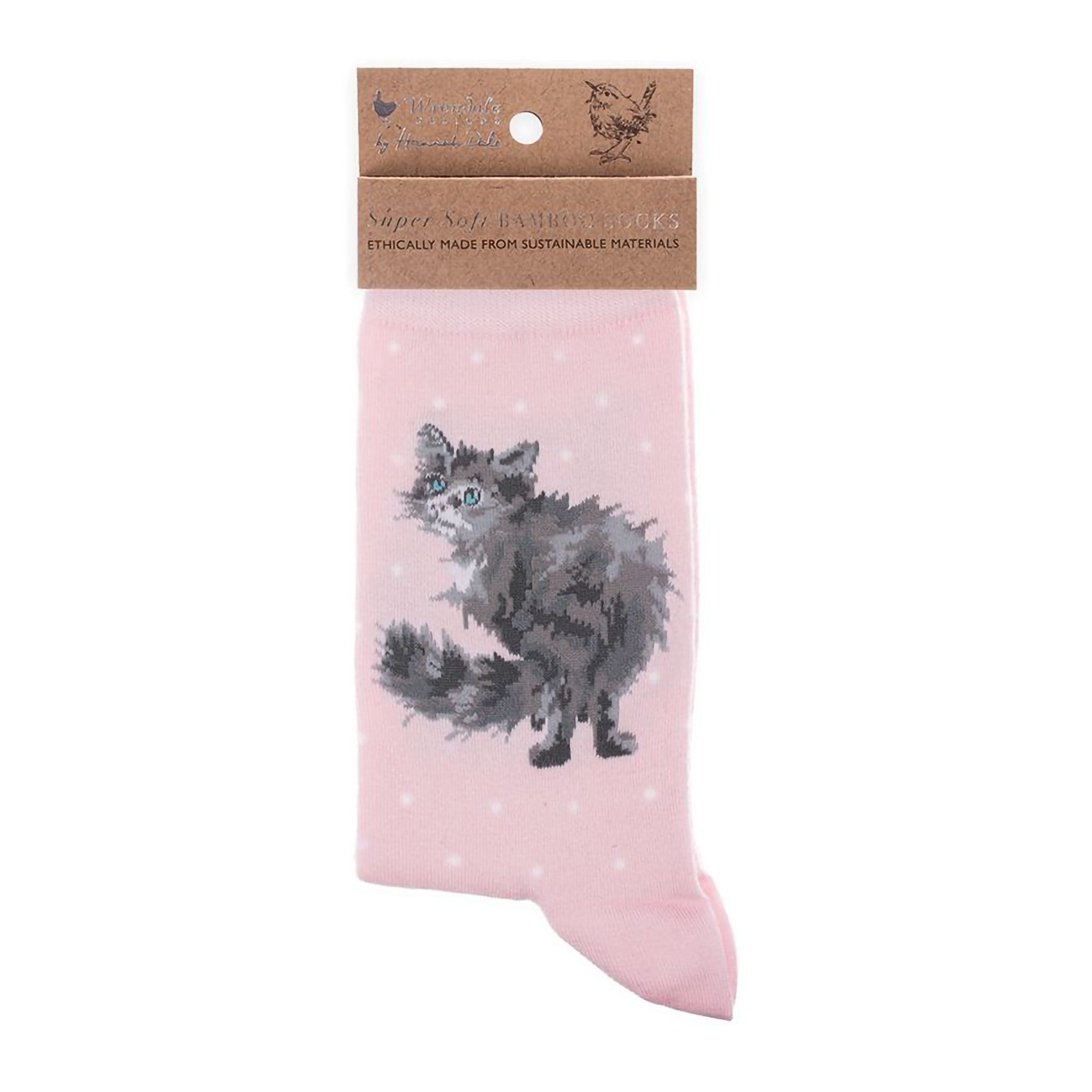 Folded pair of blush pink socks with a fluffy cat picture and white polka dots
