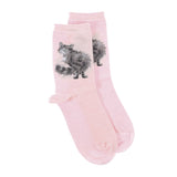A pair of blush pink socks with a fluffy cat picture and white polka dots