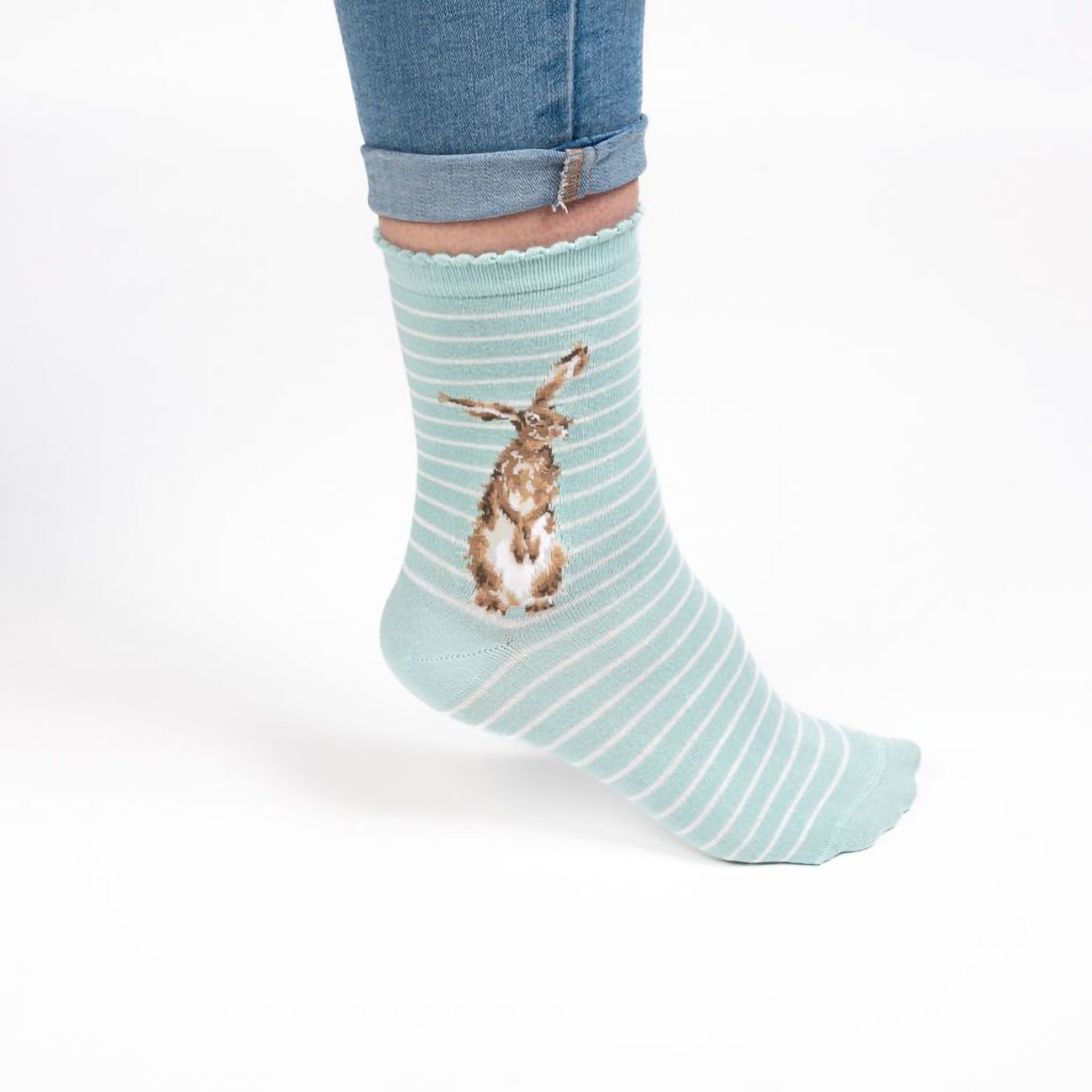 Model wearing a pair of light duck egg blue socks with a hare picture and white stripes