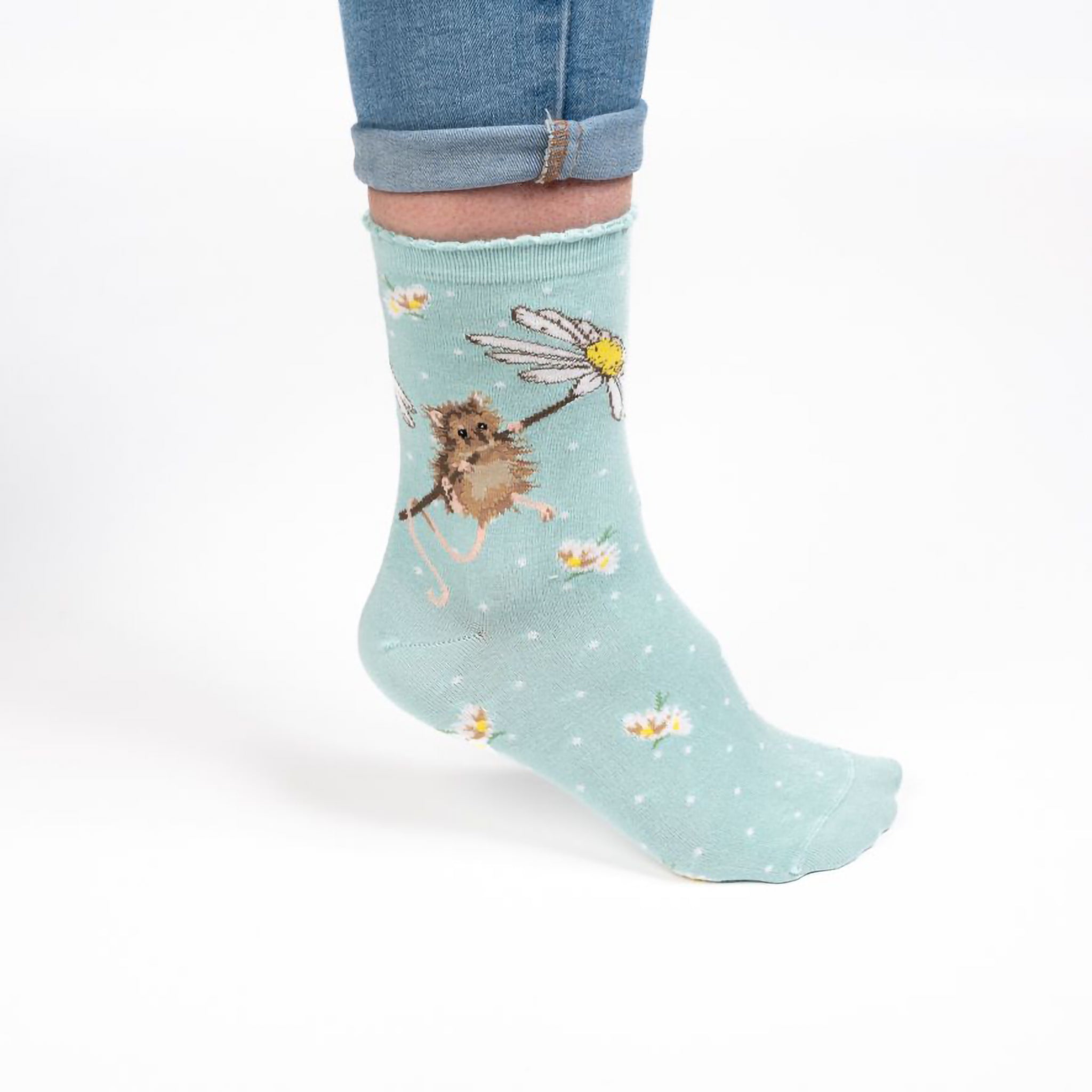 Model wearing a pair of light blue socks with a mouse holding a daisy picture and white polka dots