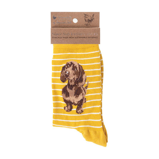 Folded pair of yellow socks with a little sausage dog picture and white stripes