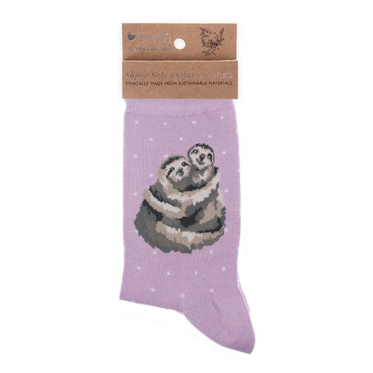 Folded pair of purple socks with a picture of two cuddling sloths and white polka dots